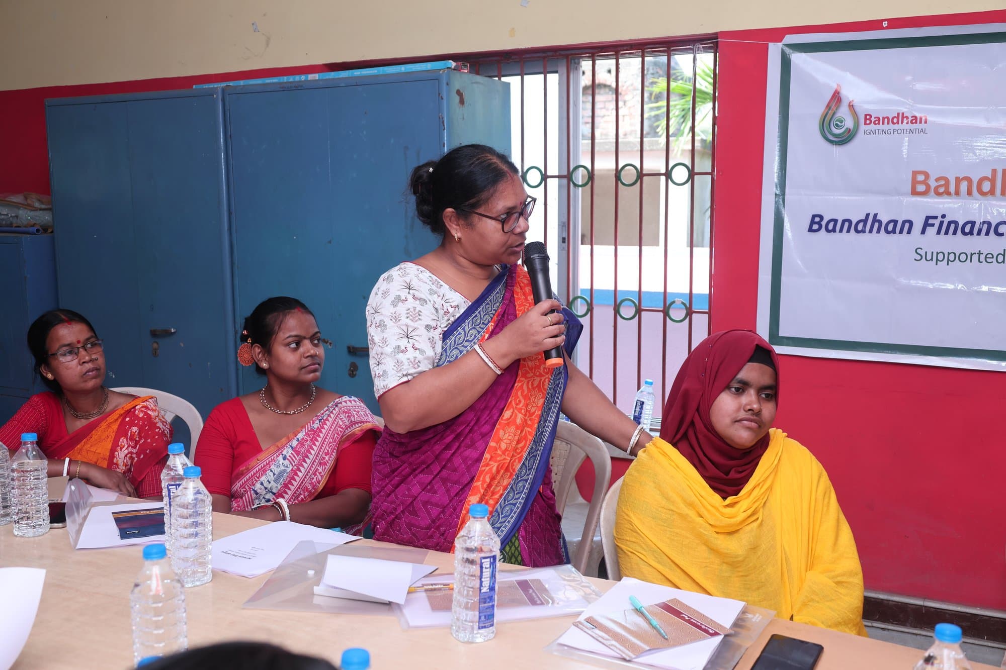 A participant in Baruipur standing to speak into the microphone
