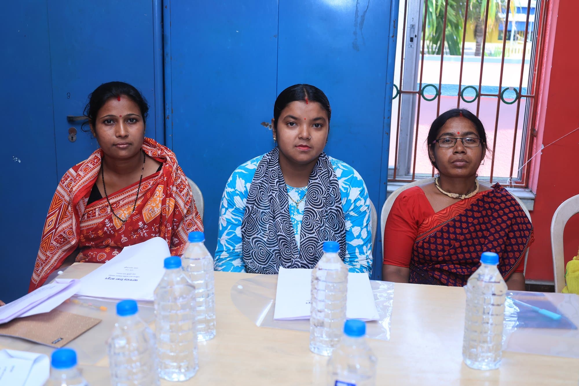 Three participants seated together at a workshop in Baruipur