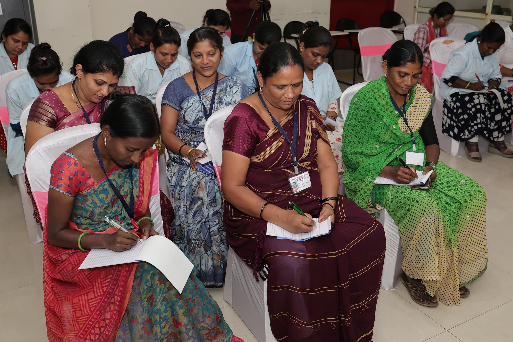 Participants in Kolhapur writing notes during a session